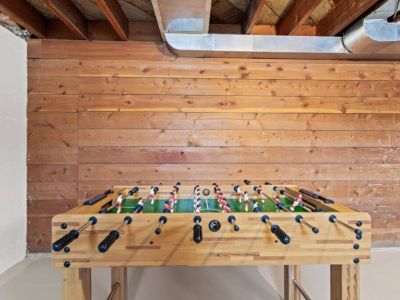 The lower level game room is a big hit for adults and kids  alike. It is shared with the laundry room.