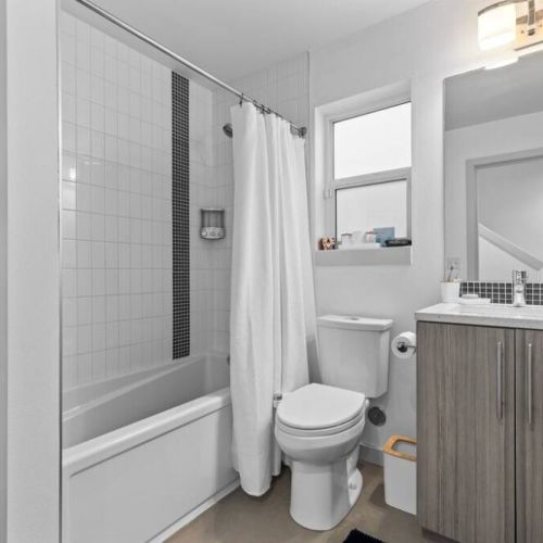 Main Floor Full Bathroom: Shower/Tub, Bidet, with shelves for your personal items