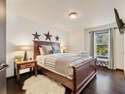 Relax in comfort in this queen bedroom, featuring a plush & inviting bed for a restful night's sleep. Stay entertained with the 42" Smart TV, charge your devices with the USB lamps, and create a soothing atmosphere with the sound machine.