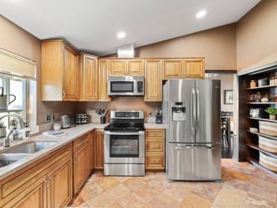 Experience the joy of cooking and entertaining in this spacious kitchen, fully stocked with everything you need for culinary creations. From top-of-the-line appliances to ample counter space and storage, this kitchen is a chef's dream come true