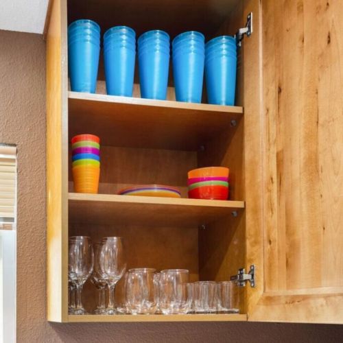 The abundance of cups and glasses in this well-stocked kitchen adds a touch of convenience and sophistication to your dining experience.