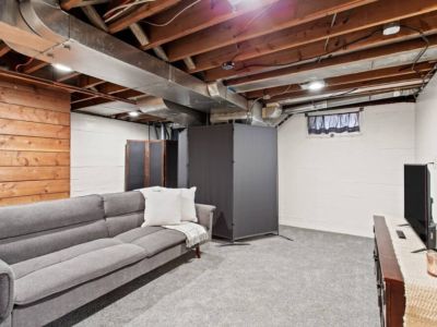 Welcome to our inviting downstairs living room. The comfortable futon couch provides versatile seating while enjoying your favorite shows and movies on the smart TV.