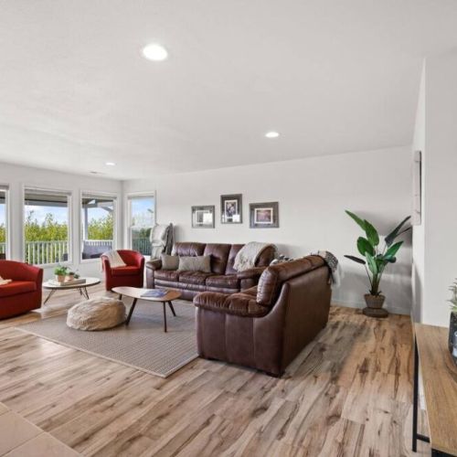 Floor-to-ceiling windows invite the outdoors in, creating a seamless connection between the interior and the surrounding environment.