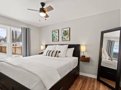 The  king bedroom is on the main floor and features bedside lamps with usb charging station, extra pillows, cozy blankets, and a floor mirror.