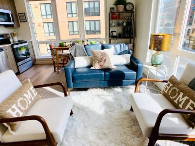 Living Room comfortably seats four with the vegan leather loveseat and two linen club chairs. The faux sheepskin rug is soft and cozy to sit on too.