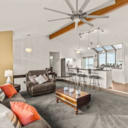 Open Concept Great Room has additional seating at the kitchen island and comfortable reclining sofa and chair.