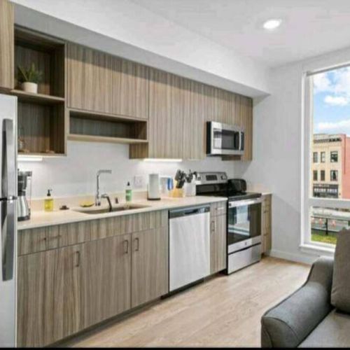 View of the full kitchen from the living room. Fully stocked and ready for you to prep your favorite home-cooked meal.