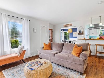 Welcome to our sunlit living room, where large windows bathe the space in abundant natural light. Bask in the glow of the sun as you unwind in this light-filled haven.