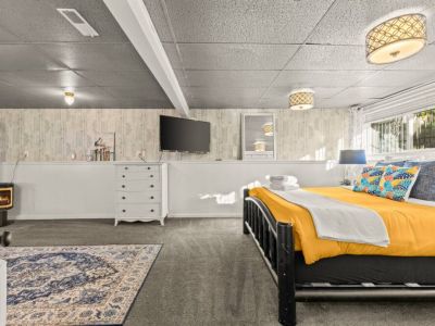 Chill in the spacious lower level King bedroom suite with its own sitting area, office desk, mini fridge, a 50" Smart TV, and a gas fireplace...nestle in.