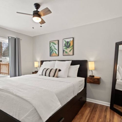 The  king bedroom is on the main floor and features bedside lamps with usb charging station, extra pillows, cozy blankets, and a floor mirror.