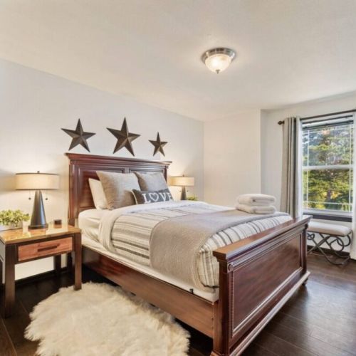 Relax in comfort in this queen bedroom, featuring a plush & inviting bed for a restful night's sleep. Stay entertained with the 42" Smart TV, charge your devices with the USB lamps, and create a soothing atmosphere with the sound machine.