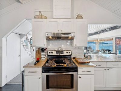 Prepare a gourmet meal or simply enjoy a morning cup of coffee, this modern white kitchen is a symphony of form and function, where simplicity meets sophistication, making every culinary endeavor a delightful experience.