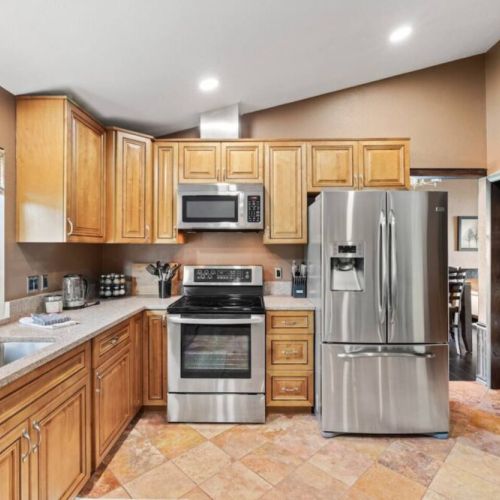 Experience the joy of cooking and entertaining in this spacious kitchen, fully stocked with everything you need for culinary creations. From top-of-the-line appliances to ample counter space and storage, this kitchen is a chef's dream come true
