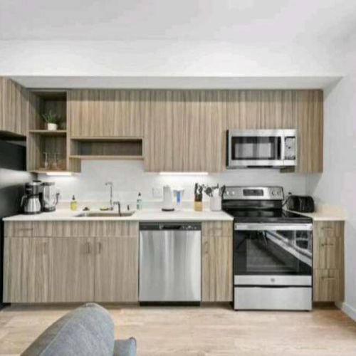 From the rhythmic hum of appliances to the gleam of stainless steel, this kitchen is the essence of a space where meals are crafted with love and shared with joy