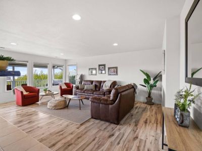 Floor-to-ceiling windows invite the outdoors in, creating a seamless connection between the interior and the surrounding environment.