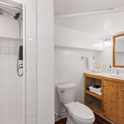 Lower-level half bath is conveniently located near the queen bedroom.