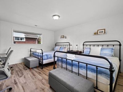 A generously spacious bedroom features two comfortable Queen beds, providing ample space for relaxation and rejuvenation.