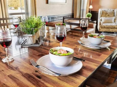 The warm and inviting ambiance of the room is enhanced by soft lighting and tasteful decor, creating the perfect setting for intimate dinners or lively gatherings.