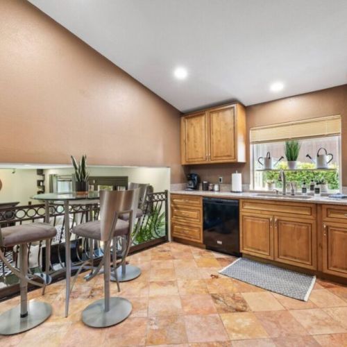 Discover the heart of the home in this well-equipped kitchen featuring a charming coffee nook, perfect for your morning brew. The kitchen offers a spacious layout and modern appliances for preparing delicious meals.