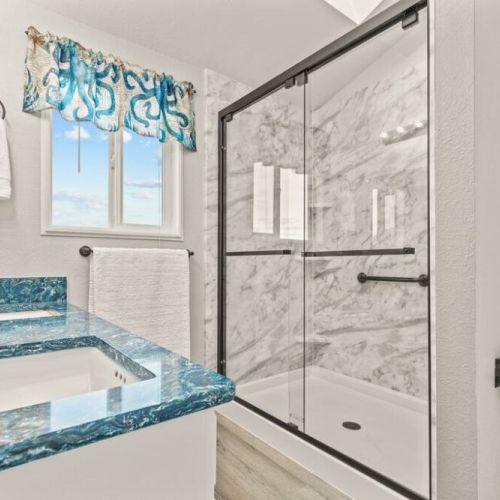 King En Suite Bathroom with large walk-in shower and custom "ocean" quartz countertop.