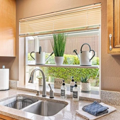 Experience the sleek and modern design of the stainless steel sink in this contemporary kitchen. The stainless-steel material not only adds a touch of elegance but also offers durability and easy maintenance.