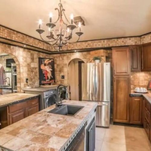 The Prep Kitchen is adjacent to the Chef's Kitchen and includes a second refrigerator, dishwasher, two sinks, large pantries, and front loading washer and dryer.