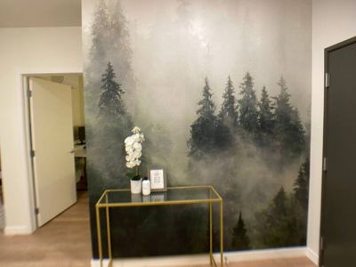 As you step through the door, the entryway transforms into an artistic gateway, adorned with a captivating wall mural that sets the tone for the entire space